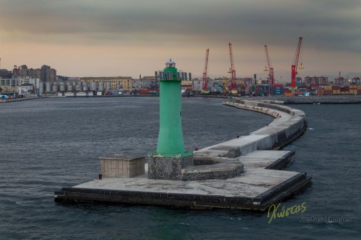 Green Lighthouse at sunset. Napoli, Italy