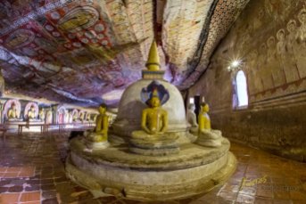 A Stupa with various Buddha statues inside the cave temple, the ceiling is decorated with amazing paintings that keep their colors for a few thousand years...