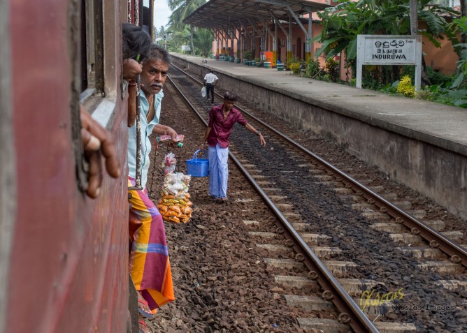 Getting on and off the train at each station (obviously not from the proper platform), these street sellers were having snacks and water. Induruwa, Sri Lanka.