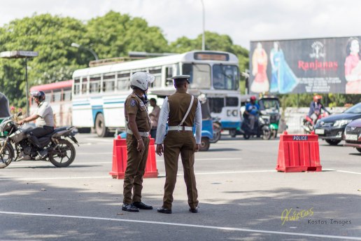 Street traffic in Sri Lanka is insane some times. Police officers standing inside a crossroad triangle in City Center, Colombo, Sri Lanka.