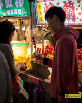 Sugar Coated Cherry Tomato, combination of sweet and sour taste. One of the countless options for food in Shilin Night Market, Taipei, Taiwan.