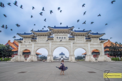 Portrait and birds in front of the famous Chiang Kai-Shek Memorial Hall Gate. A huge construction and temples with endless possibilities for photography. Also with plenty of people visiting. Took us a long wait for this photo to happen. Taipei, Taiwan.