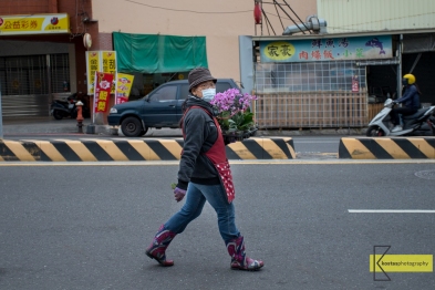 Candid shot of a lady florist walking in the street of Tainan with flower coordinated boots. My camera is always ready for situations like that.