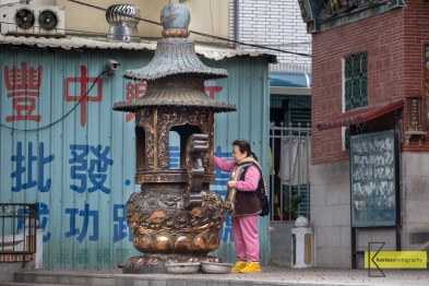 While traveling for photography I like to include local people in their daily activities. Like this lady during her morning prayer in Tainan.